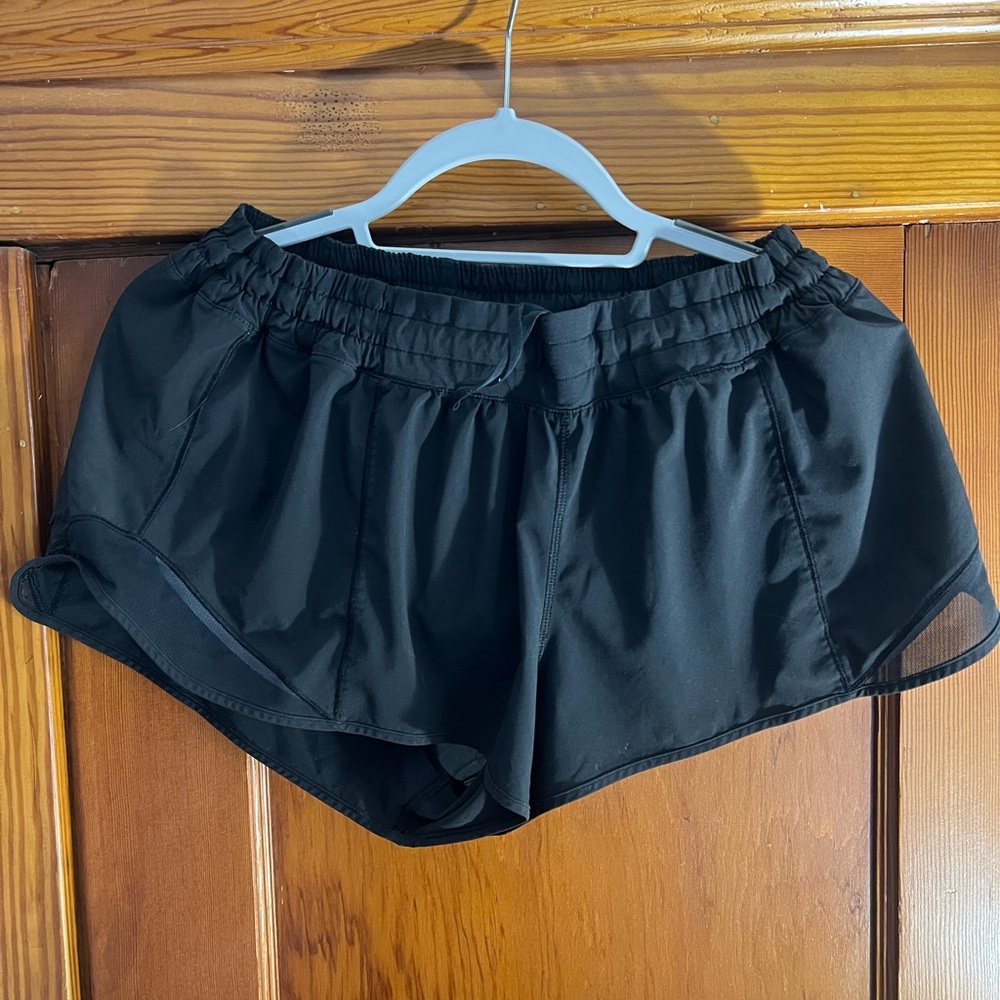 LULULEMON HOTTIE HOT black shorts 2.5” size 10 - Tear/defect on bottom side!
